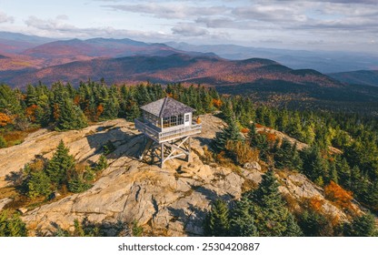 Aerial View New England Fire Tower Fall Foliage Autumn Season. High Angle Wide View October. Girl Stands Watch. Forest and Mountains Sunny Day. - Powered by Shutterstock