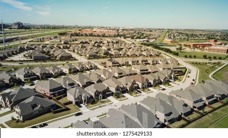 Aerial View New Residential Neighborhood Situated Between Highway And School District Near Dallas, Texas, USA. Row Of Single-family Houses With Gardens