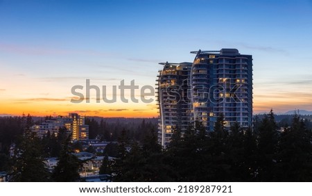 Aerial View of a New Residential Property Building. Modern Architectural Design in a suburban city. White Rock, Vancouver, British Columbia, Canada. Sunset Sky