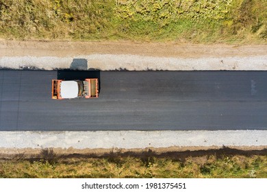 Aerial View Of New Road Construction With Steam Roller Machine At Work.