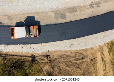 Aerial View Of New Road Construction With Steam Roller Machine At Work.