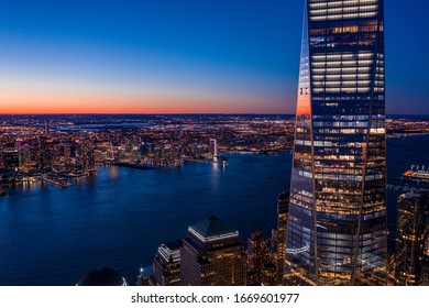Aerial view of New York city and one world trade center brookfield place at dusk.