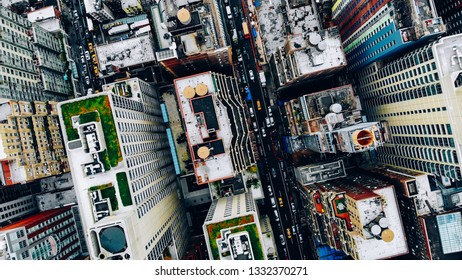 Aerial view of New York downtown building roofs with water towers. Bird's eye view from helicopter of cityscape metropolis infrastructure, traffic cars moving on city streets and district avenues - Shutterstock ID 1332370271