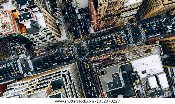 Aerial view of New York downtown building roofs.
Bird's eye view from helicopter of cityscape metropolis
infrastructure, traffic cars, yellow cabs moving on city streets
and crossing district
avenues