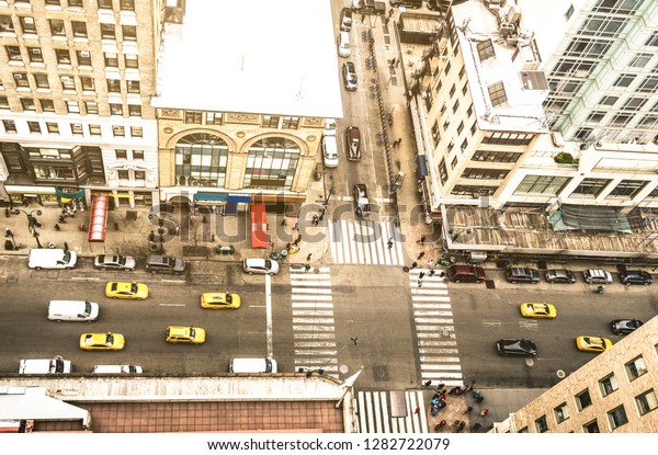 Aerial view of New York street and classic\
building in Manhattan financial district - High angle from\
skyscraper in urban business downtown area - United states world\
famous city - Warm vintage\
filter