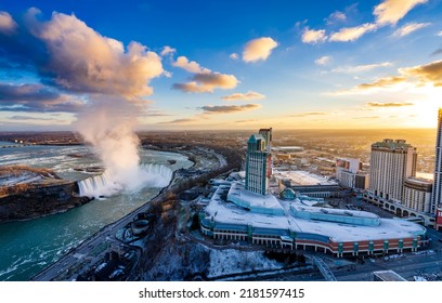 Aerial view of Niagara Falls City downtown horizon and Horseshoe Falls in a winter sunny day sunset time.