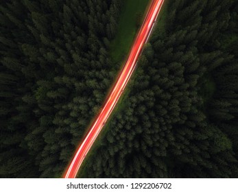 Aerial View Of Night Green Forest,  Road And Cars Passing By. Drone Shot. 