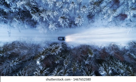 Aerial View Of Night Winter Road And Car In Forest. Drone Shot.	