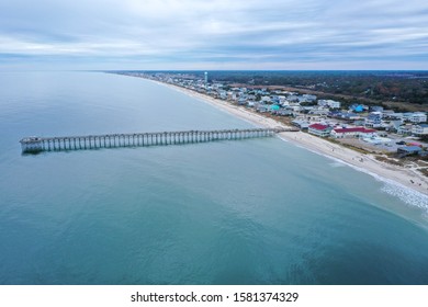 Aerial view of the Ocean Crest Pier at Oak Island NC. Over the water, looking over the pier and the beach front.