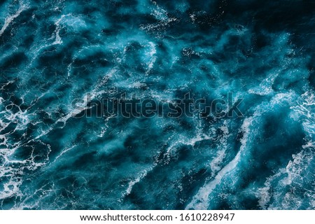 Aerial view to ocean waves. Blue water background. Dramatic colors photo.