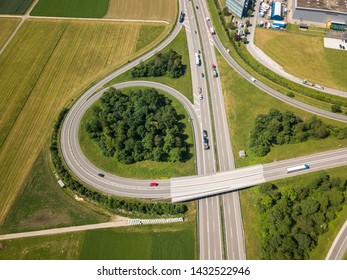 Aerial View Oensingen Switzerland Highway Intersection Traffic And Urban Sprawl Close To Jura Mountains