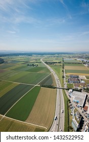 Aerial View Oensingen Switzerland Highway Intersection Traffic And Urban Sprawl Close To Jura Mountains