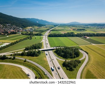 Aerial View Oensingen Switzerland Highway Intersection Traffic And Urban Sprawl Close To Jura Mountains