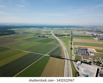 Aerial View Oensingen Switzerland Highway Intersection Traffic And Urban Sprawl Close To Jura Mountains