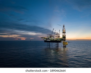 Aerial view offshore drilling rig (jack up rig) at the offshore location during sunset - Shutterstock ID 1890462664