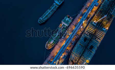 Aerial view oil and gas tanker cargo ship offshore at the port at night, Industry refinery fuel chemical import export business logistic and transportation.