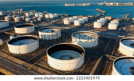 Aerial view of Oil refinery and Modern sea harbor with transhipment equipment for oil tankers, oil production plant. Crude oil tanker and Gas lpg tanker container ship.