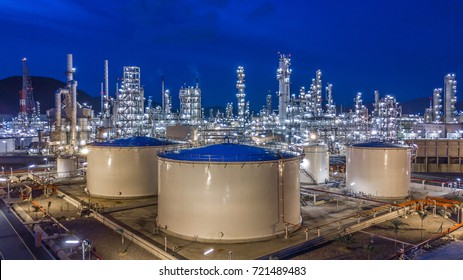 Aerial view oil storage tank with oil refinery background, Oil refinery plant at night.