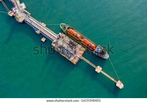 Aerial view oil tanker. Oil loading dock of business\
logistic sea going ship, Crude oil tanker lpg ngv at industrial\
estate Thailand / Group Oil tanker ship to Port of Singapore -\
import export 
