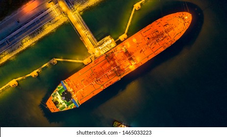 Aerial View Oil Tanker Ship At The Port At Night, Transportation And Import Export Business.