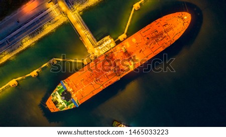 Aerial view oil tanker ship at the port at night, transportation and import export business.