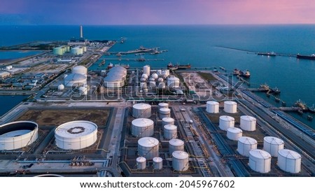 Aerial view oil terminal storage tank, White oil tank storage chemical petroleum petrochemical refinery product at oil terminal, Business commercial trade fuel energy transport by tanker ship vessel.