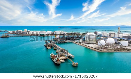 Aerial view oil treminal with storage tank farm, offshore oilrig, tanker and port, land oil rig, refinery plant, factory, gas station, Business petroleum fuel and gas transport by tanker ship vessel.