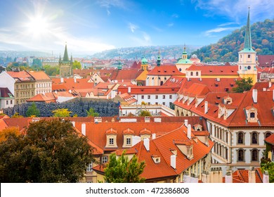 Aerial view of old Red Tiles roofs in the city Prague, Czech Republic, Europe. Beautiful Autumn day with blue sky with clouds in the town.