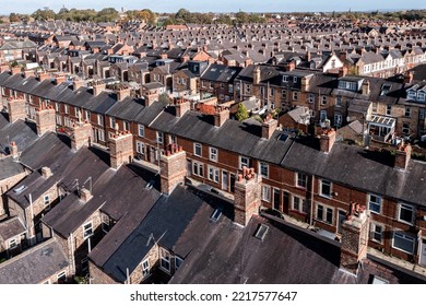 Aerial view of old terraced houses on back to back streets in the suburbs of a large UK city in the North of England - Shutterstock ID 2217577647