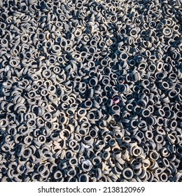 Aerial View Of Old Tires. Many Car Tires On Dump Site From Above. Huge Waste From The Automotive Industry. Ecology Background Or Texture Concept.