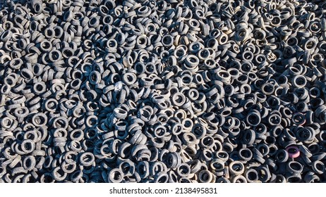 Aerial view of old tires. Many car tires on dump site from above. Huge waste from the automotive industry. Ecology background or texture concept. - Powered by Shutterstock