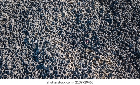 Aerial view of old tires. Many car tires on dump site from above. Huge waste from the automotive industry. Ecology background or texture concept. - Powered by Shutterstock