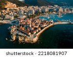 Aerial view of the old town Budva, city is surrounded by mountains. Selective focus on Montenegro. Budva with red tile roofs and high-rise buildings. Adriatic Sea View from above.