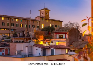 Aerial View Of Old Town Rooftops At Night In Rome, Italy.