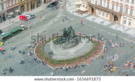 Aerial view of Old Town Square and Jan Hus monument timelapse. People sitting and walking around in Prague, Czech Republic. Top view from Old Town Hall tower