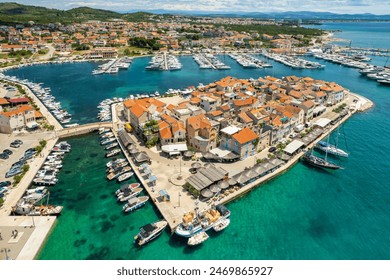 Aerial view of the old town of Tribunj on a small island in Adriatic sea, Dalmatia region of Croatia. Adriatic Town of Tribunj on small island. Historic buildings with cozy outdoor restaurants. - Powered by Shutterstock