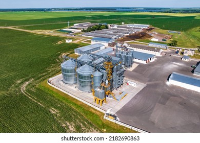 aerial view on agro silos granary elevator with seeds cleaning line on agro-processing manufacturing plant for processing drying cleaning and storage of agricultural products in rye or wheat field