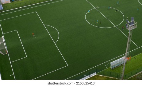 Aerial View On An Artificial Turf Soccer Field While Some Players Are Engaged In A Match