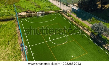Aerial view on an artificial turf soccer field with synthetic grass during a sunny day.