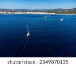 Aerial view on blue water of Gulf of Saint-Tropez, sail boats, beaches and houses of Port Grimaud, Port Cogolin, summer vacation in Provence, France