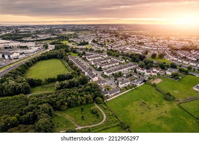 Aerial View On A City Residential Area With Houses And Park. Galway, Ireland. Blue Cloudy Sky. High Density Urban Land.