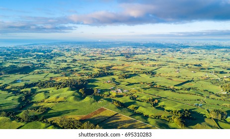 Aerial view on a farmland with stock paddocks at the foot of Mount Taranaki. Taranaki region, New Zealand - Shutterstock ID 695310283