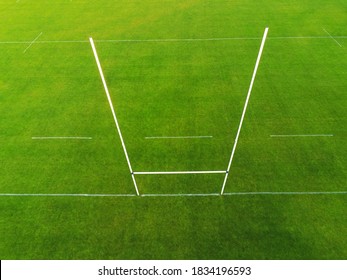 Aerial View On A Green Grass Training Pitch With Tall Goal Posts For Popular Irish National Sports: Hurling, Camogie,gaelic Football, Rugby. Nobody On The Pitch. Outdoors Activity Concept