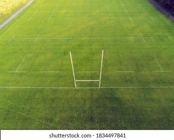 Aerial View On A Green Grass Training Pitch With Tall Goal Posts For Popular Irish National Sports: Hurling, Camogie,gaelic Football, Rugby. Nobody On The Pitch. Outdoors Activity Concept