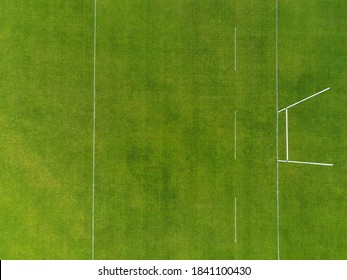 Aerial View On A Green Grass Training Pitch With Tall Goal Posts For Popular Irish National Sports: Hurling, Camogie,gaelic Football, Rugby. Nobody On The Pitch. Outdoors Activity Concept