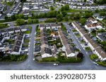 Aerial view on high density living area with houses built close to each other and park. Residential area in Ireland with private housing. City planning and developing concept.