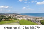 Aerial view on houses on coast of see in Newcastle, Northern Ireland. Coastal town, Drone photo