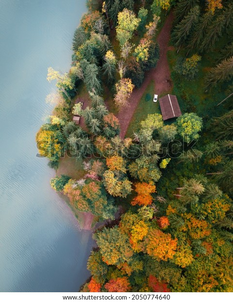 Aerial view on lake with turquoise water in\
Carpathian Mountains. Autumn forest with orange trees on coast.\
Tereblia-Ritske Reservoir (Vilshanske) on Tereblia river,\
Transcarpathian region,\
Ukraine
