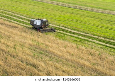 Aerial view on older combine harvester machine working in field. Agriculture view from above.  - Shutterstock ID 1145266088