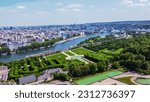 Aerial View on Paris  and Seine river  from Boulogne-Billancourt   (Saint-Cloud)  with   consert hall   "Musical Seine" Domain of Saint-Cloud with garden pools and topiary trees  and statues.